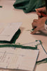 Leim Sewing workshops - jumpsuit sewing workshops - a person working with paper patterns and the green cut out fabric. Sewing pattern adjustments & alterations