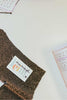 Leim Sewing workshops - jumpsuit sewing workshops - Gold textured fabric with a MeMadeLeim label with parts of a paper sewing pattern showing